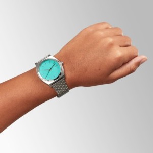 Nixon watch with silver bracelet and turquoise dial