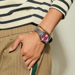 Nixon watch with silver bracelet and pink dial