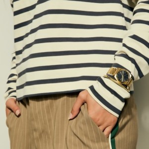 Nixon watch with gold bracelet and black dial