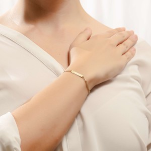 14K gold ID bracelet with engraved ladybug design