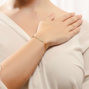 14K gold ID bracelet with crown motif and evil eye charm