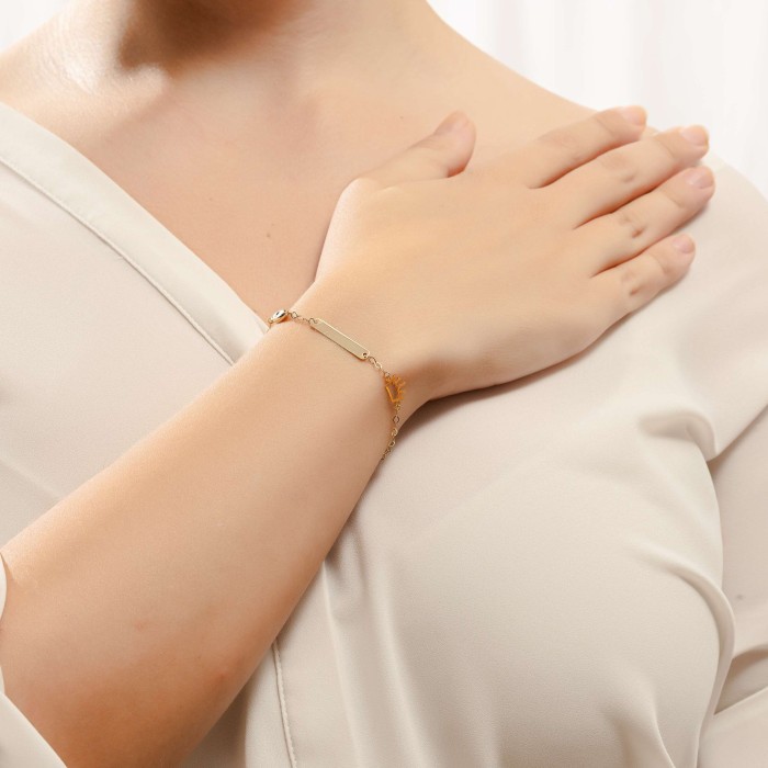 14K gold ID bracelet with crown motif and evil eye charm