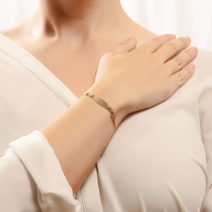 14K gold ID bracelet with cross motif and evil eye charm