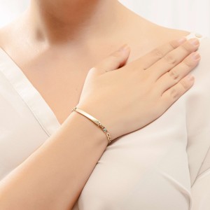 14K gold ID bracelet with blue stones